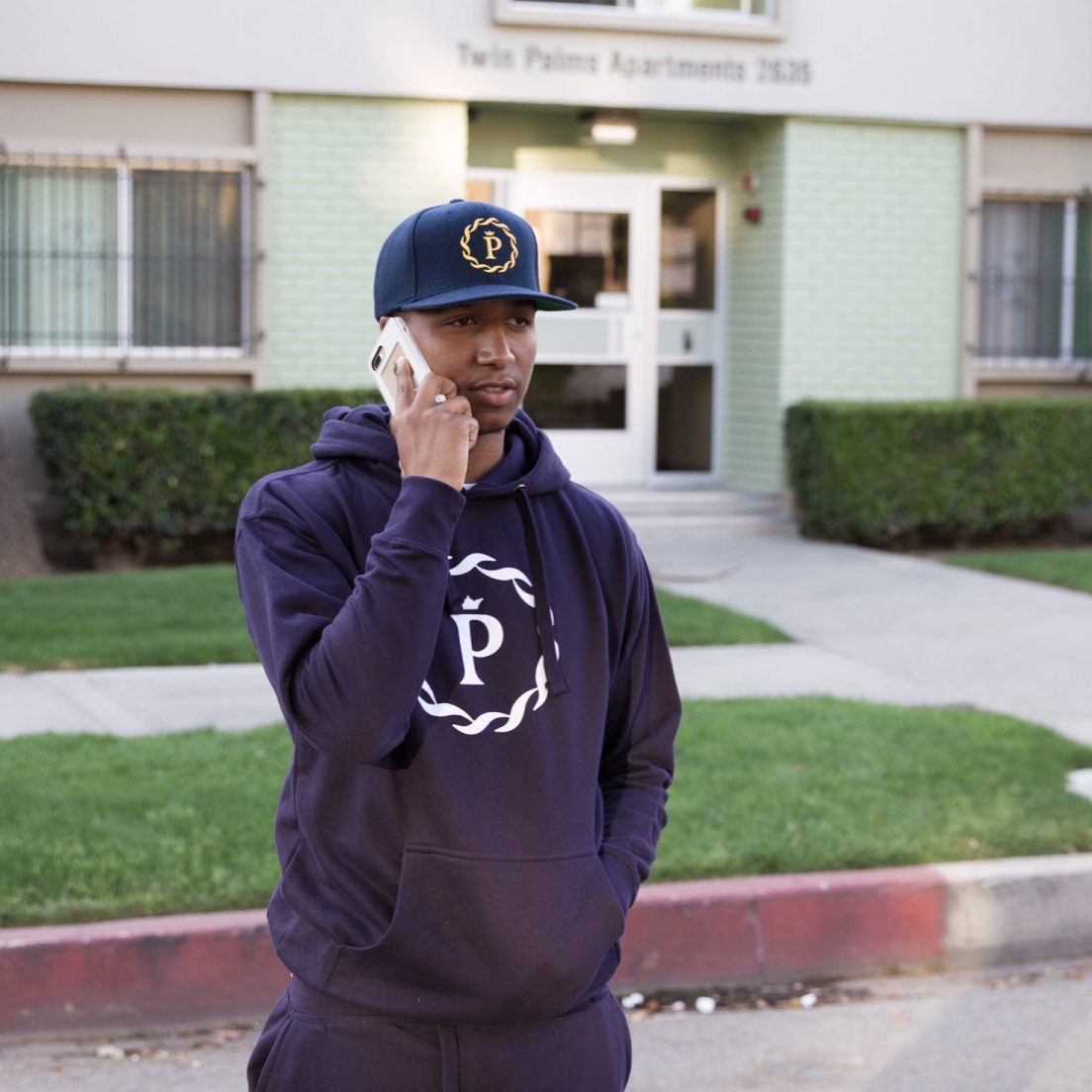 Armand Perry (CBA Peez) in PRCZN Blue Sweatshirt + Navy Hat